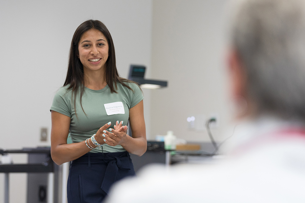 Paulina Esguerra speaks in front of a group