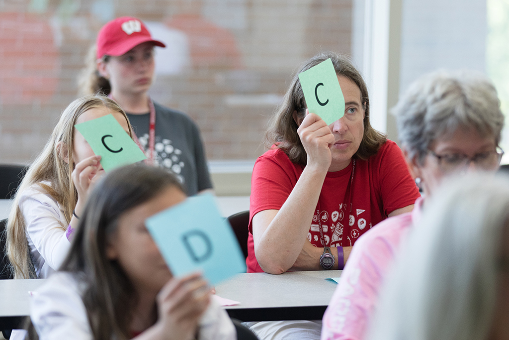 Attendees hold up letters