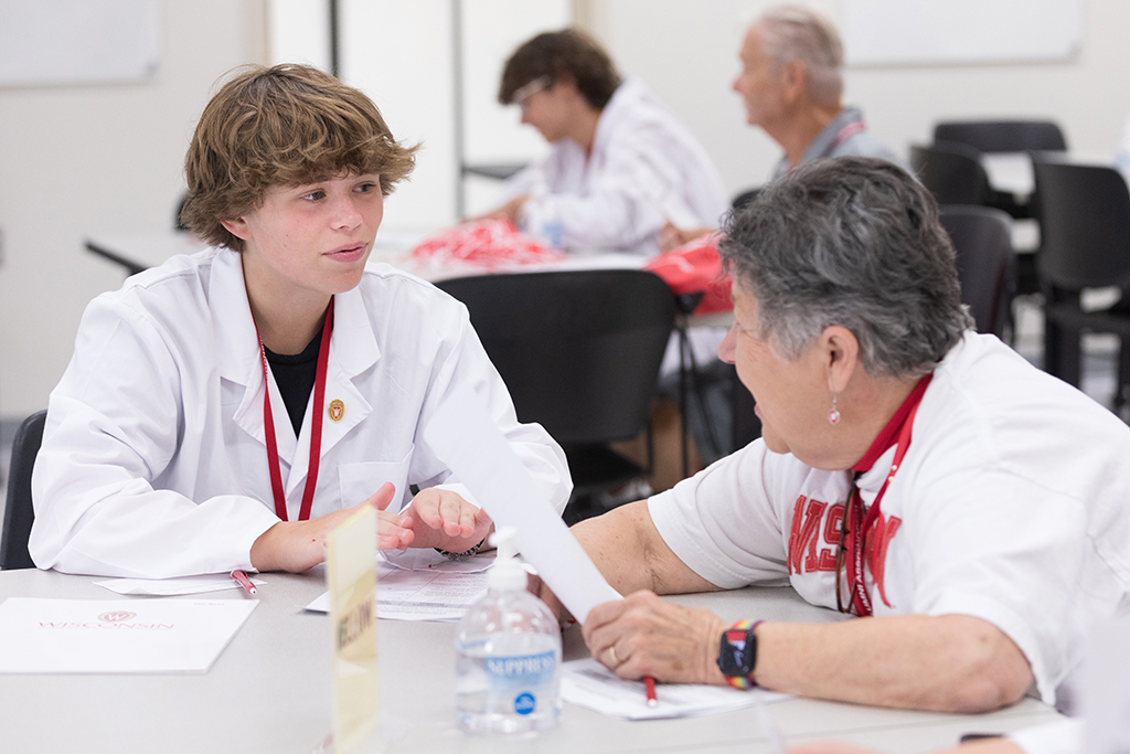 A pair of attendees discuss their worksheet