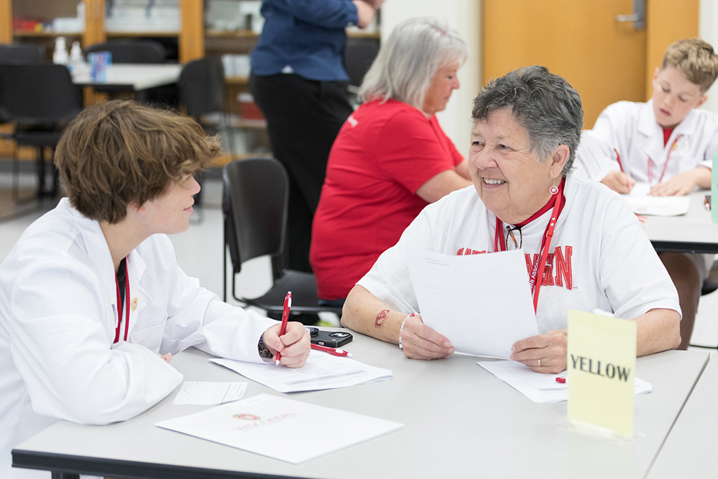 A pair of attendees discuss their worksheet