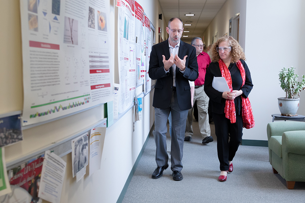 Tim Bugni giving Chancellor Mnookin a tour of the School of Pharmacy, walking through the hallway
