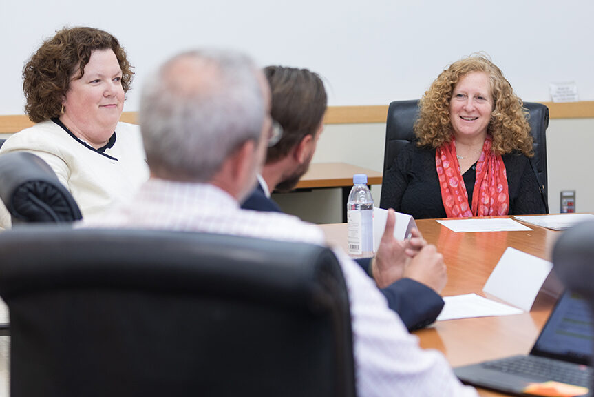 Chancellor Mnookin talking with staff in a conference room