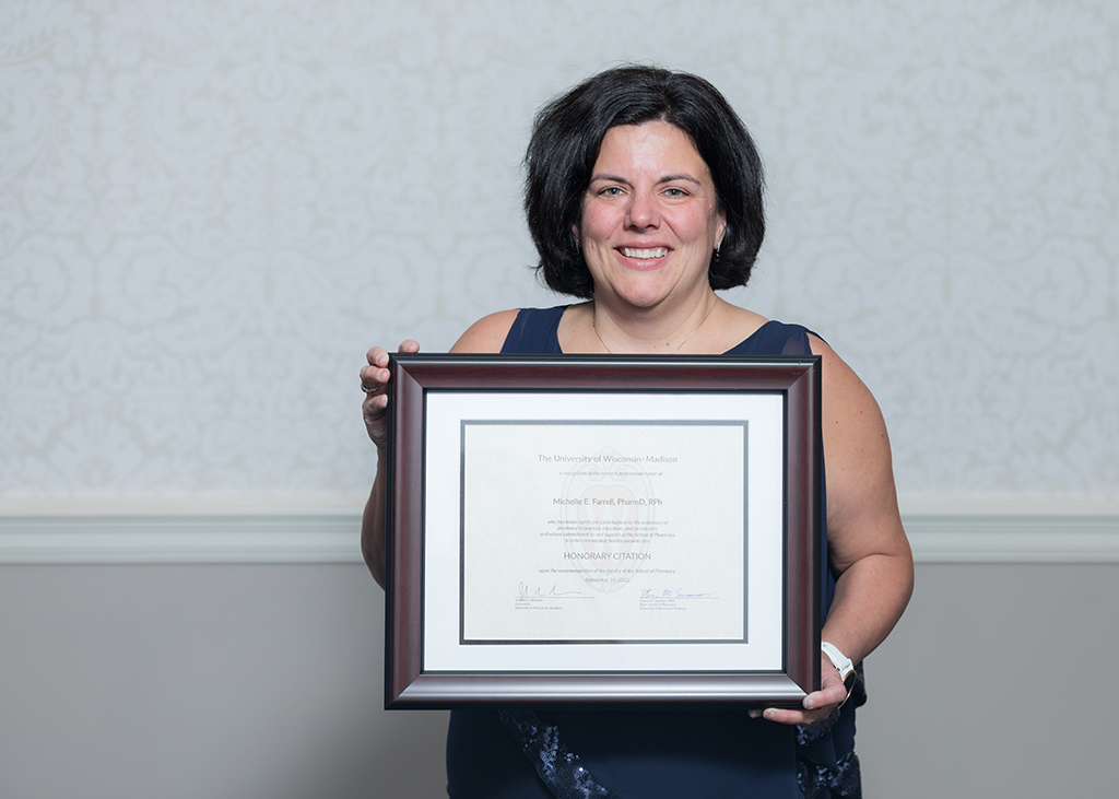 Michelle Farrell holds her Citation of Merit award.