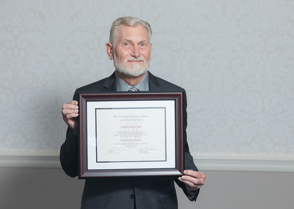 Ron Sorkness holding his Citation of Merit.