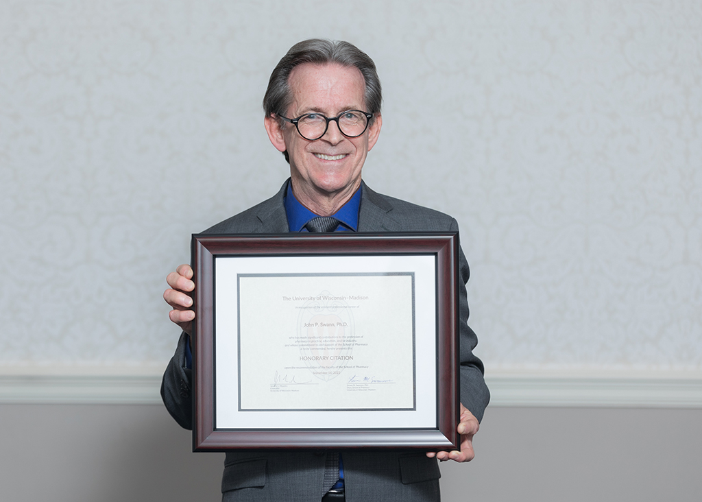 John Swann holding his Citation of Merit award.