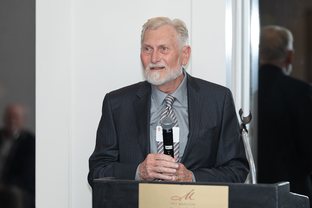 Ron Sorkness speaking at a podium.