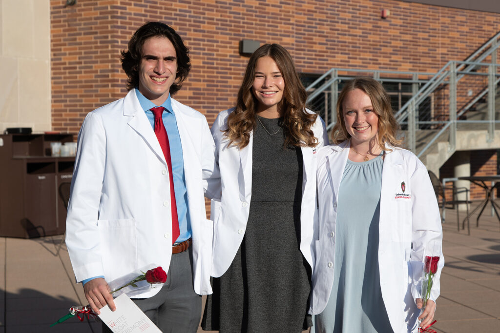 Pharm students wearing their white coats together after white coat ceremony