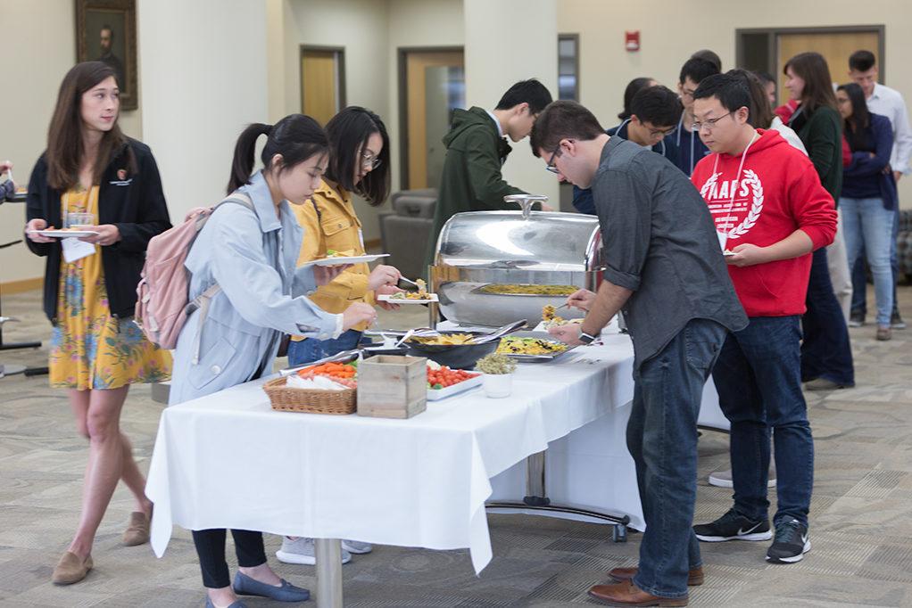 Students getting food from buffet table