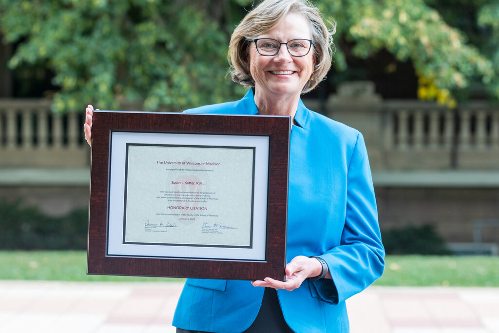 Sue Sutter holding her Citation of Merit award