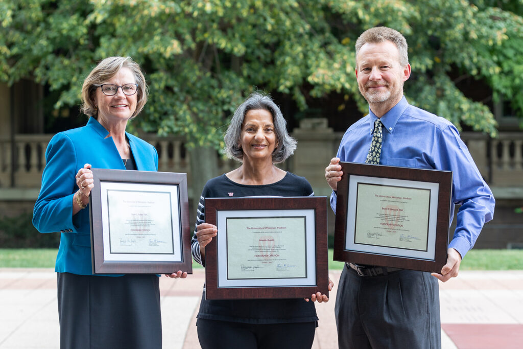 Susan Sutter, Nita Pandit, and Bruno Hancock together holding their Citation of Merit awards
