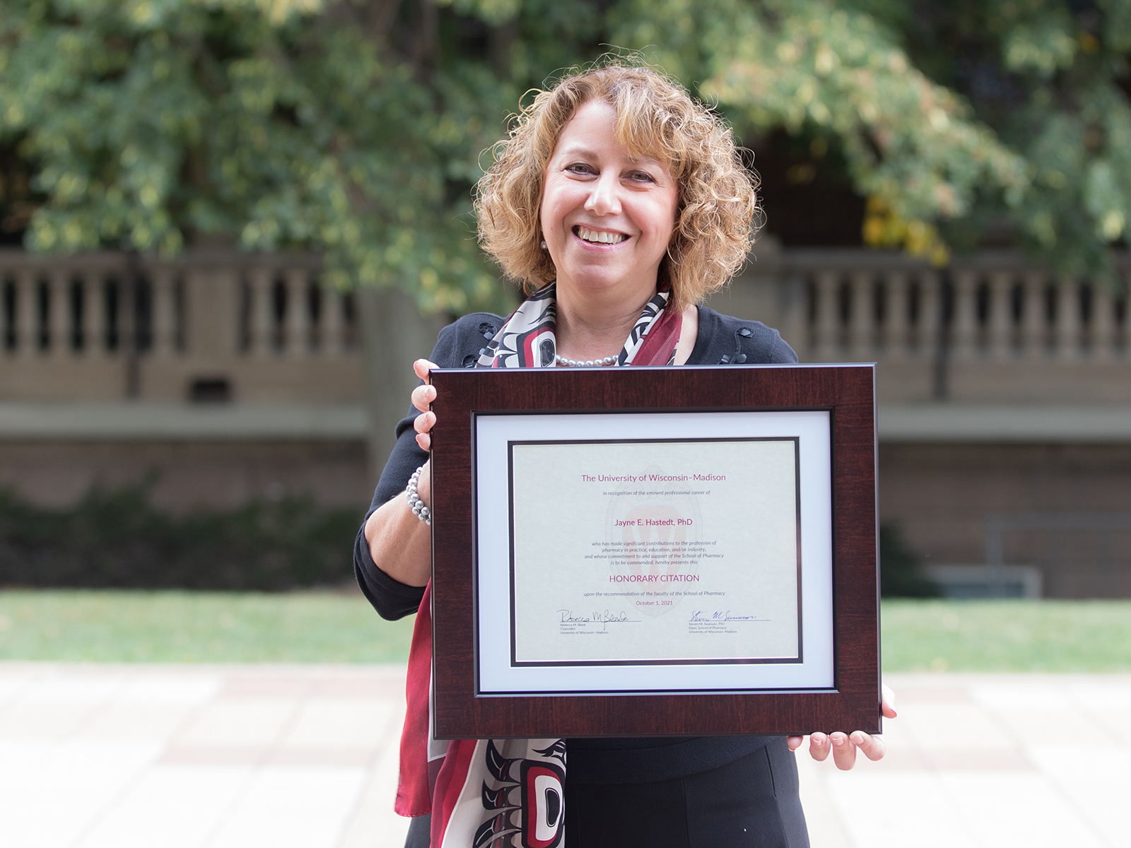 Jayne Hastedt poses with her framed Citation Award