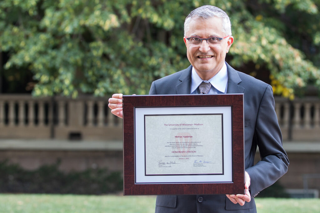 Mehran Yazdanian holding his Citation of Merit award