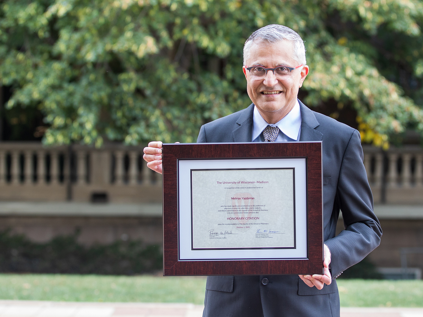 Mehran Yazdanian holding his Citation of Merit award