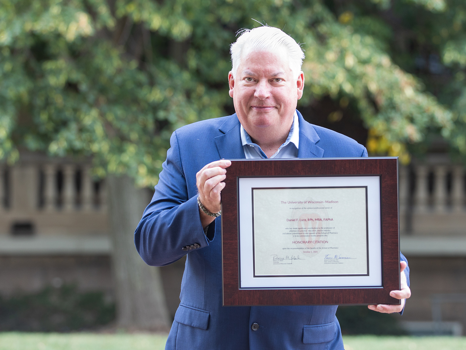 Dan Luce poses with his framed Citation of Merit award