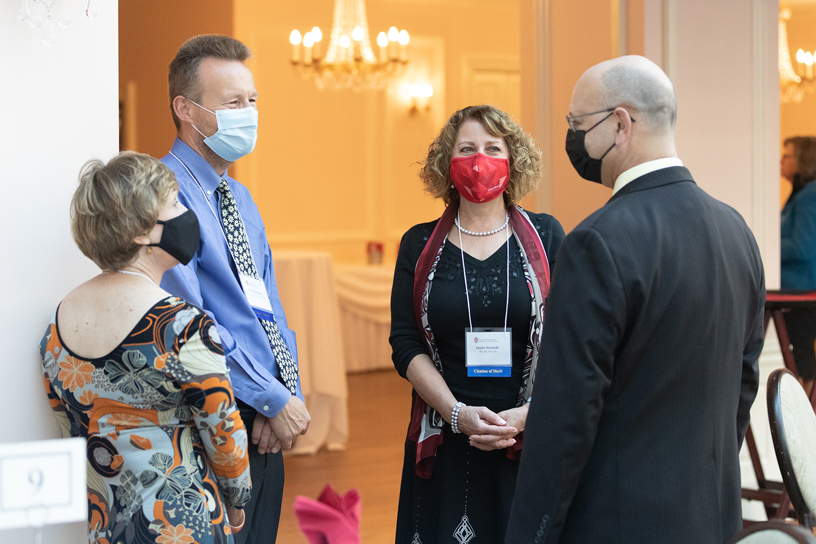 Pharm Alumni talking together at event
