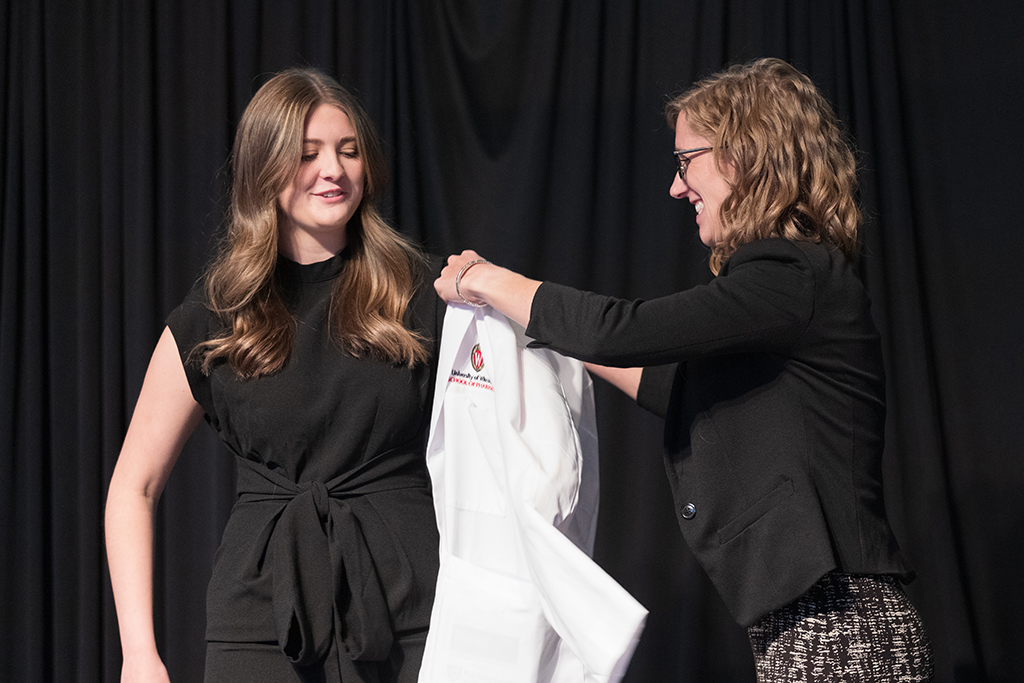 A student receives a white coat during the 2022 White Coat Ceremony.