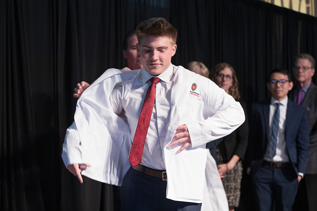A student receives a white coat during the 2022 White Coat Ceremony.