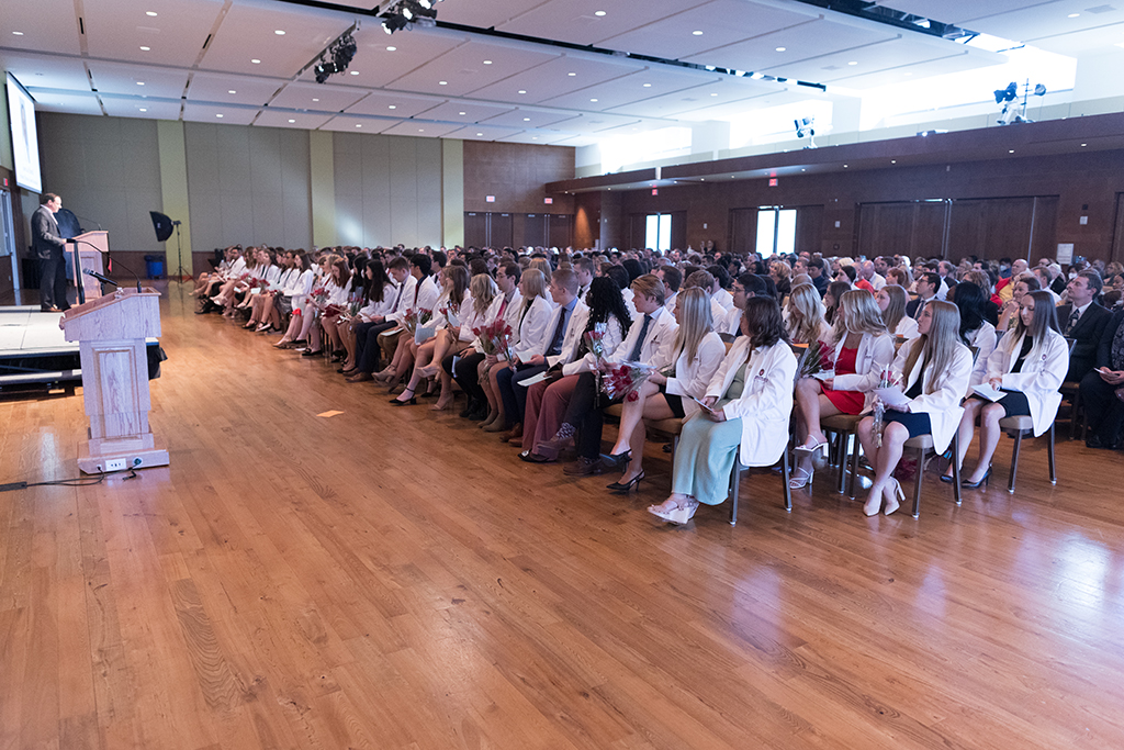 PharmD students in the Class of 2026 watch a speaker during the 2022 White Coat Ceremony.