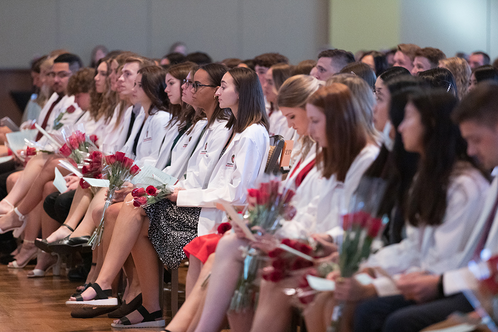 PharmD students in the Class of 2026 watch a speaker during the 2022 White Coat Ceremony.