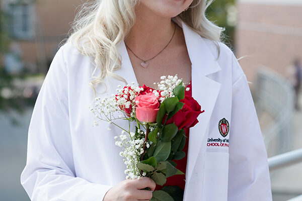 A student poses outside of the White Coat Ceremony.