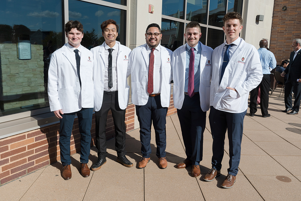 A group of students pose outside after the 2022 White Coat Ceremony.
