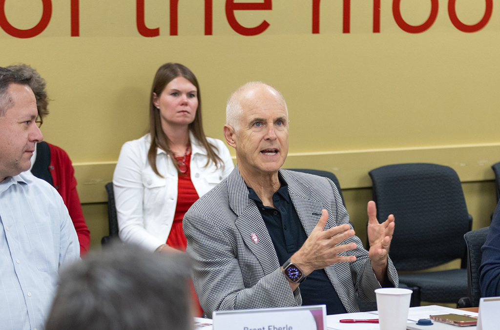 Mark Rogge speaks at a table