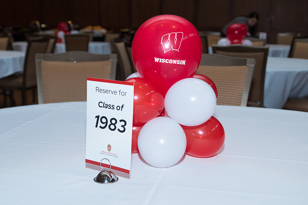 Table with balloons and sign reading "Reserve for Class of 1983"