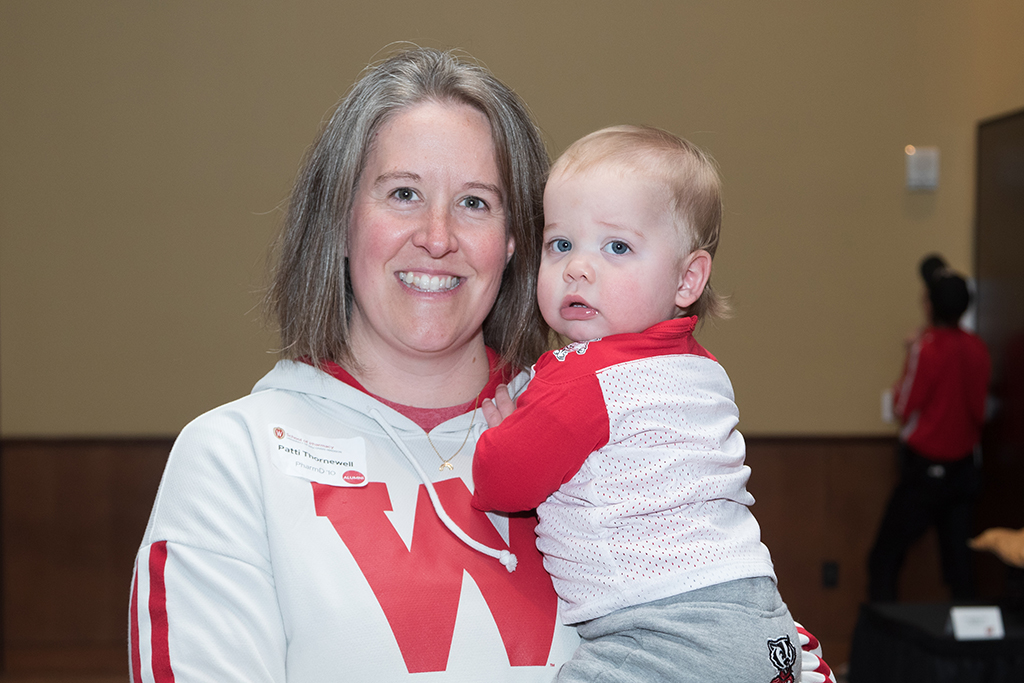 Patti Thornewell holding her grandson in badger gear