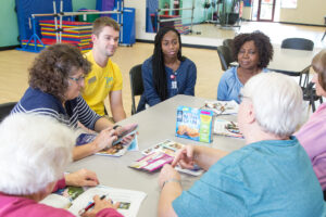 PharmD students speaking to a table of older adults about healthy food options