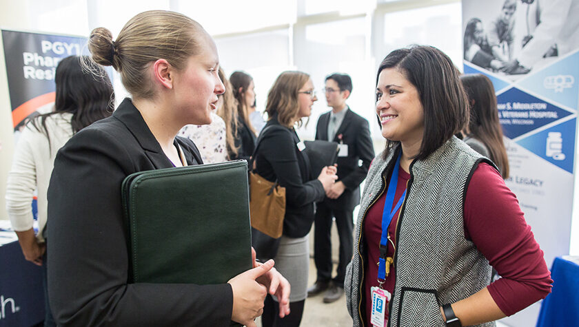 Maria Wopat (PharmD '10) chats with a pharmacy student at the annual Career Fair