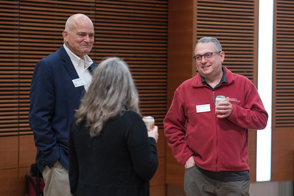 Paul Hutson and Paul Marker speak with another attendee