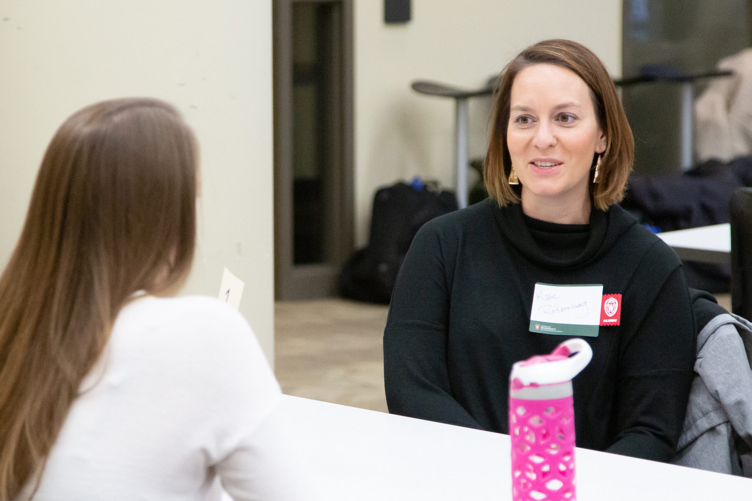 Kate Rotzenberg speaking with a student