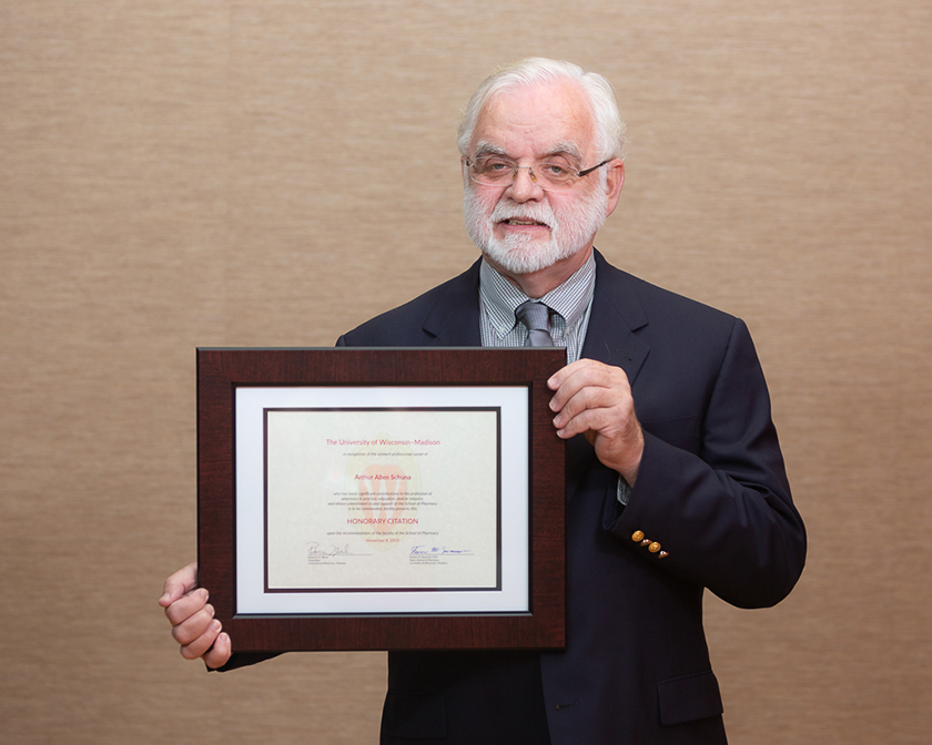 Art Schuna holding his Citation of Merit award.