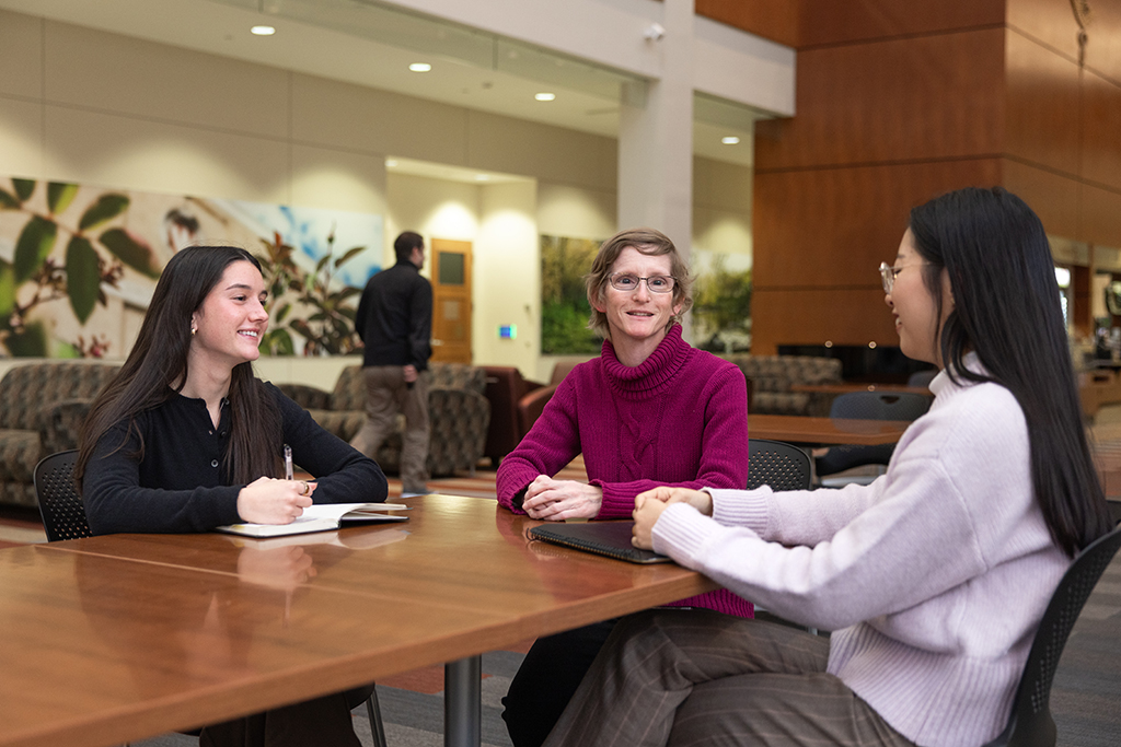 Kristi Jones, Jessica Liu, and Kira Kirsch speak around a table