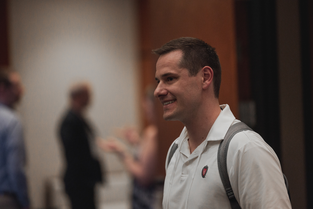 A male attendee smiles