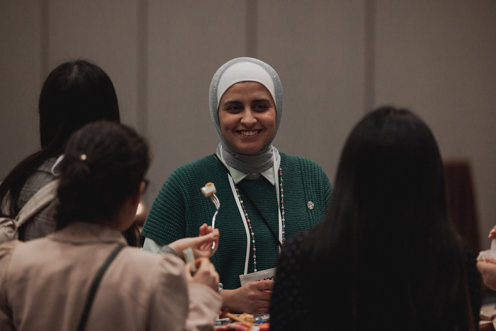 Sura AlMahasis speaks with other attendees