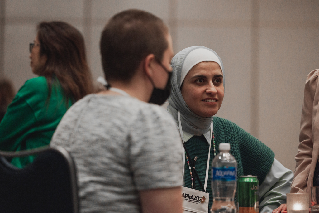 Sura AlMahasis speaks with an attendee