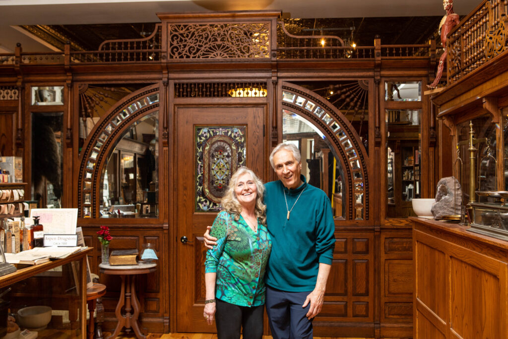 Nancy Losinski Haggar with her husband, Curt, near the ornate wooden entrance to their historical collection.
