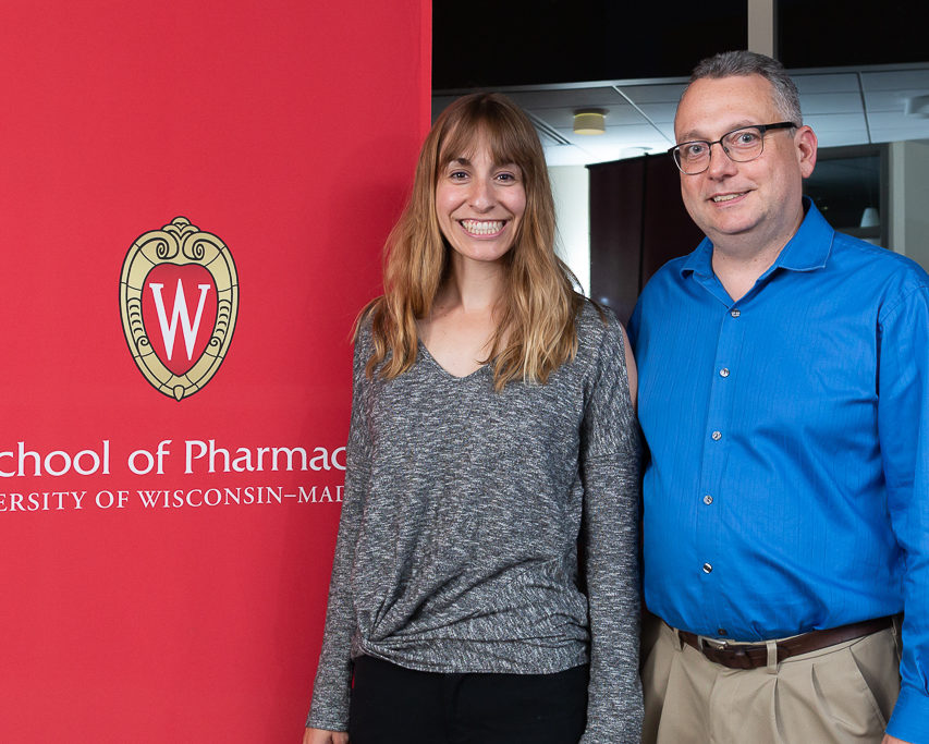 Anne Turco, scholarship recipient, with professor Paul Marker next to School of Pharmacy banner