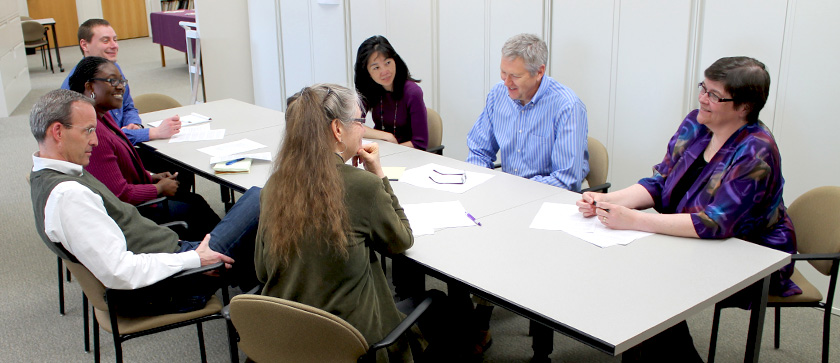 Sonderegger Research Center members sit around a table at a meeting