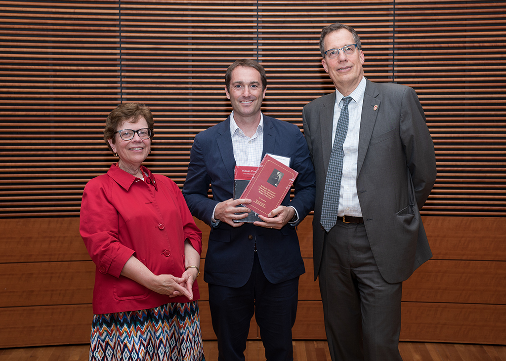 Warren Rose holds his Vilas award, flanked by Chancellor Becky Blank and interim Chancellor John Karl Scholz.