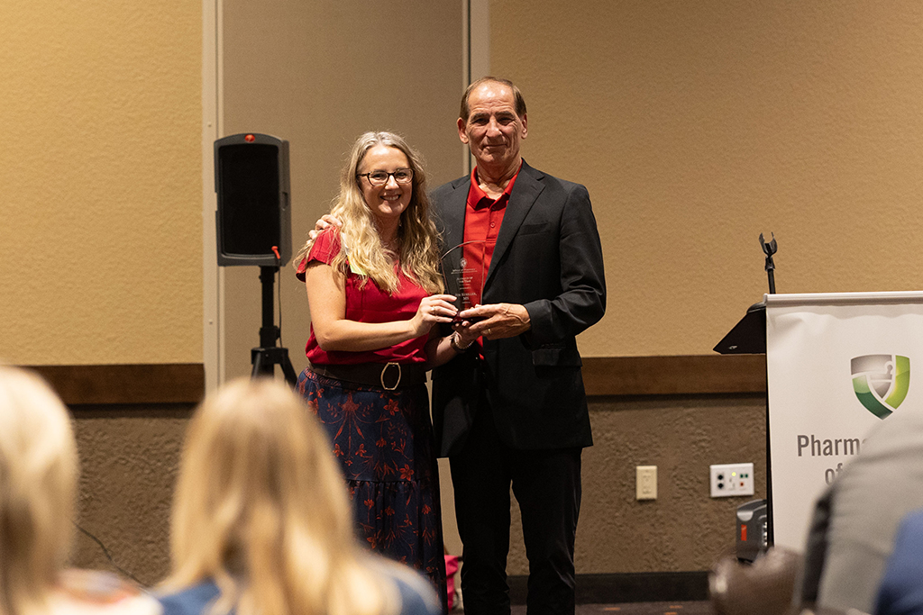 Jim Koeller receives his award from Jenny Tempelis